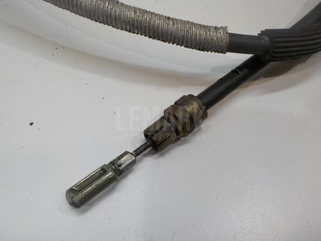Трос стояночного тормоза левый