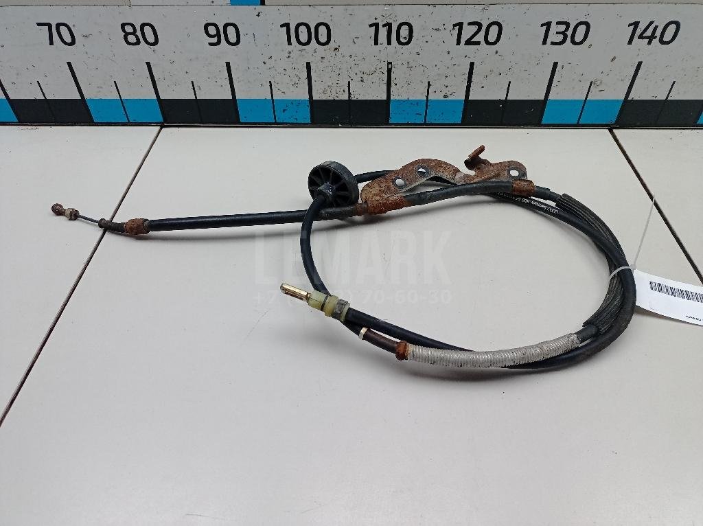 Трос стояночного тормоза левый